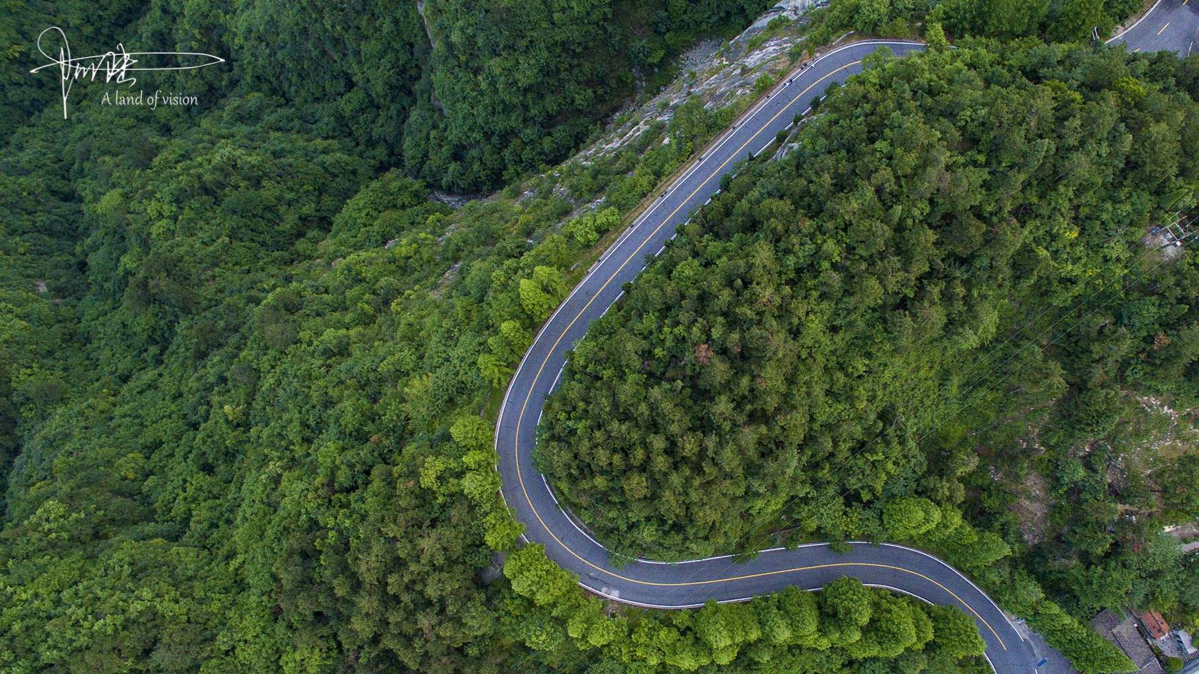 航拍武当山的山路蜿蜒如蛟龙嵌于层峦叠翠中