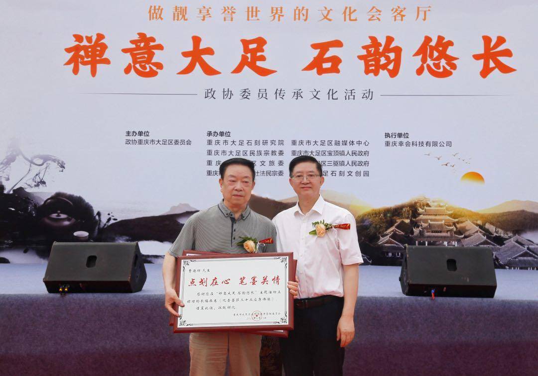 70岁高龄的曹德辉老先生将自己创作的玉雕《滴水观音