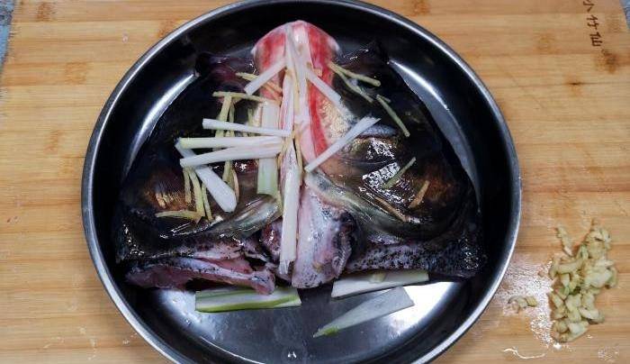 2.将鱼头内部清洗干净,黑色薄膜一定要去除掉.1.在鱼背部将鱼头