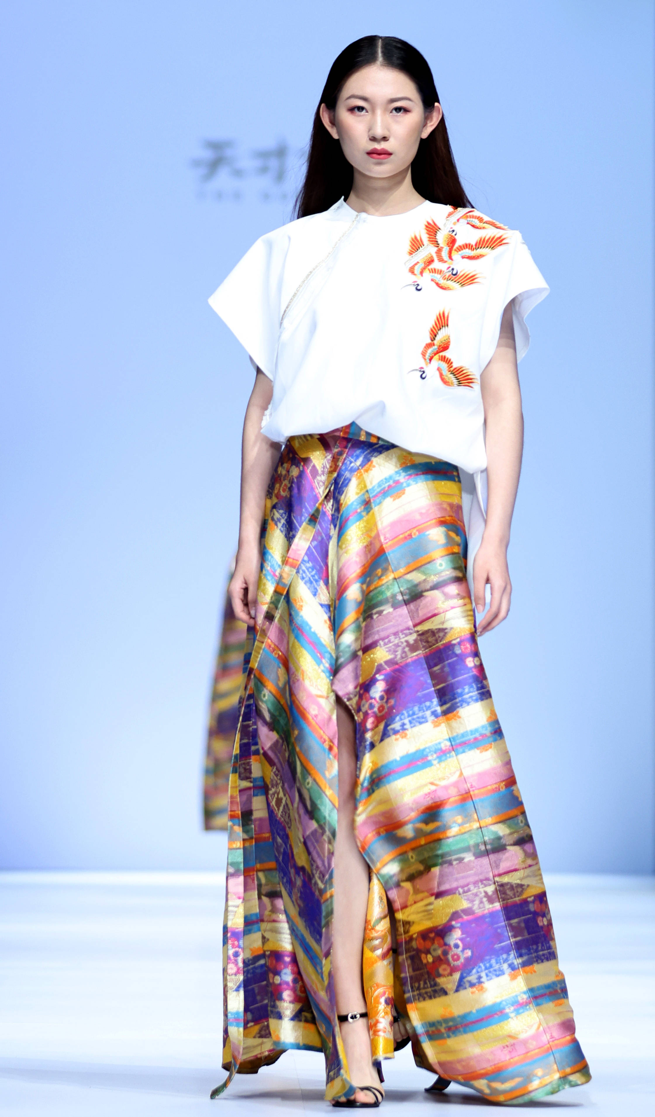 4月13日,模特在公益时装秀上展示时装设计师张肇达及其女儿张凯惠联合