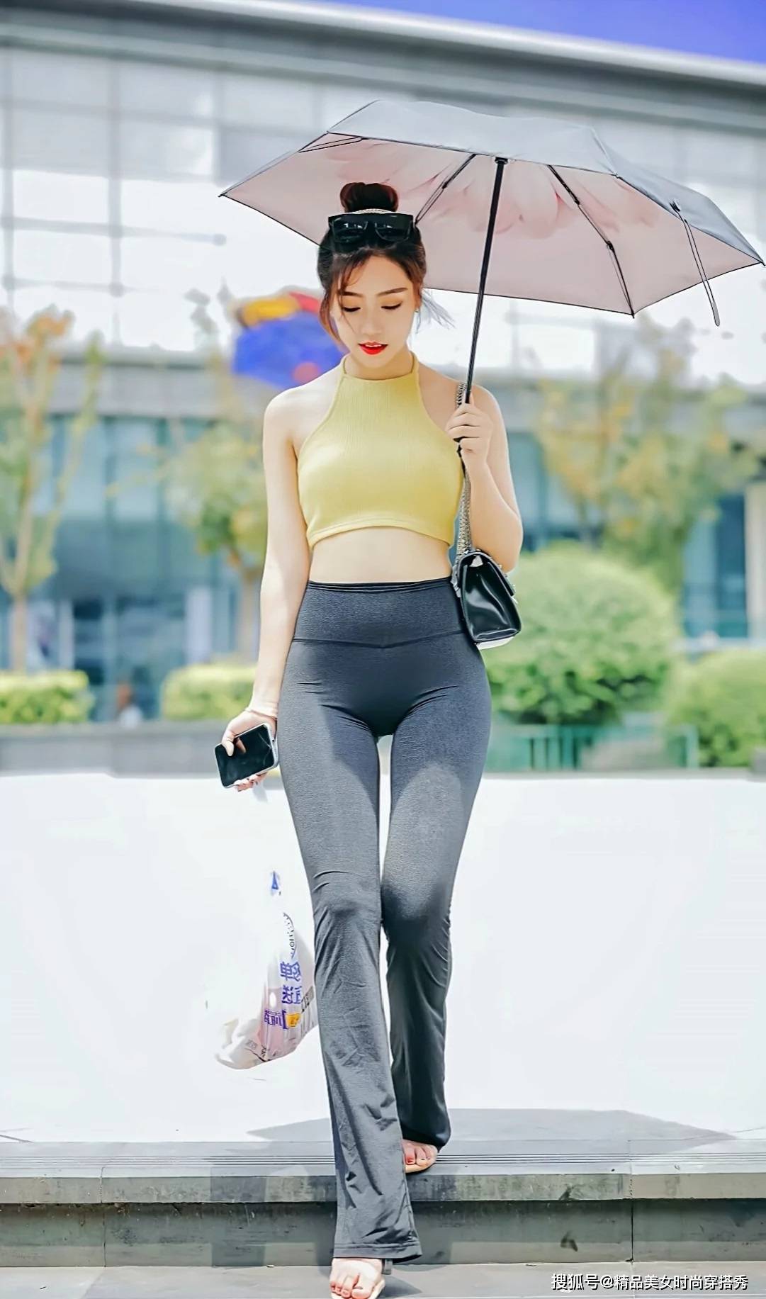 个性 黄色的挂脖背心清凉吸睛,下搭一条黑色的紧身喇叭裤,休闲又性感