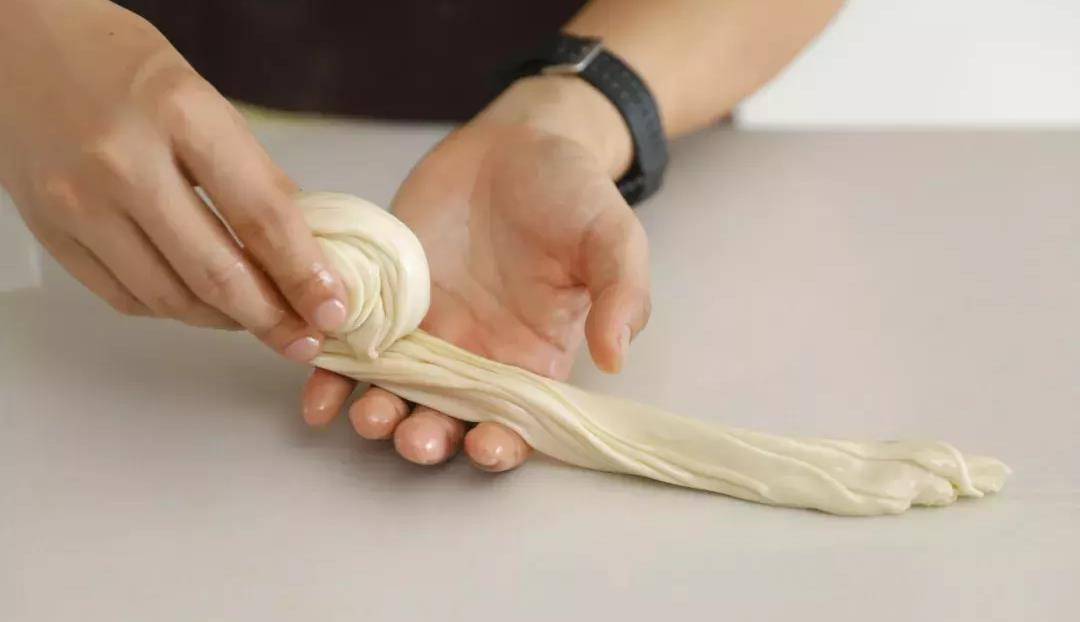 11,再将饼胚压扁,用擀面杖擀成饼皮.另一份面团也是如此操作.