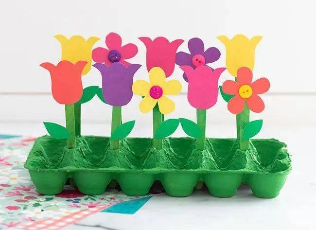 6,最后,把制作好的花儿全部插在鸡蛋纸箱做的"大草地"上,一个漂亮的大