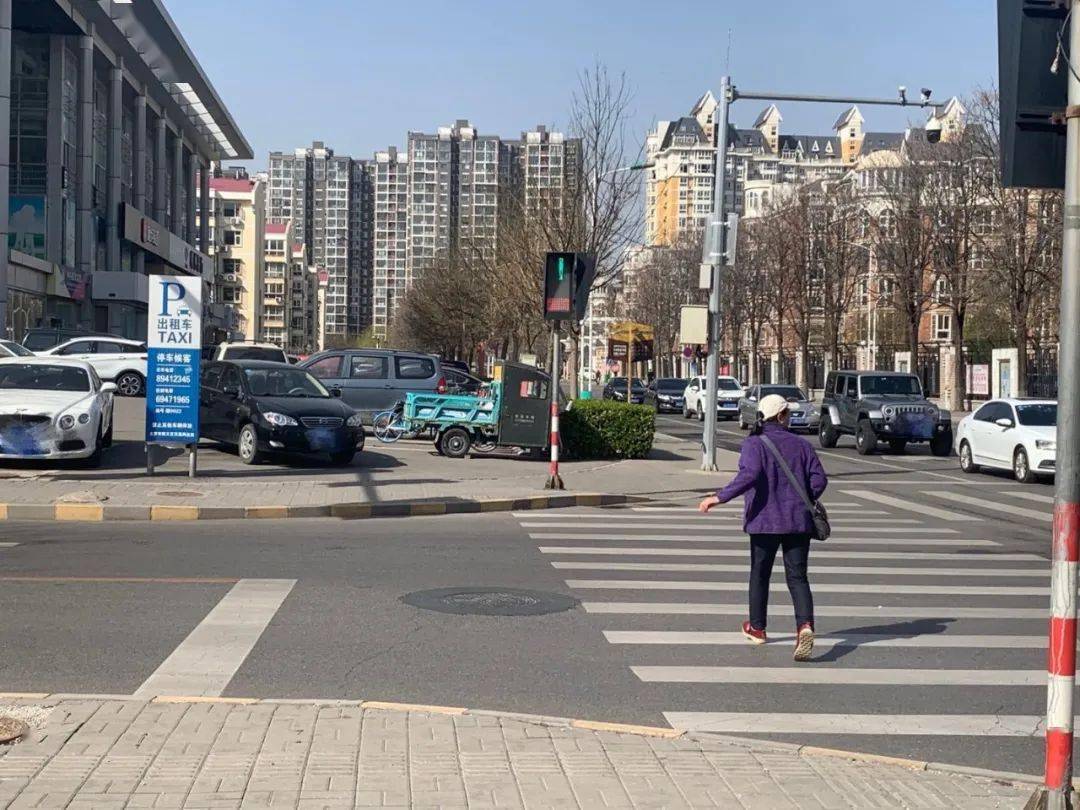 人行道信号灯一半红,一半绿 "有的行人怕错过绿灯,小跑着到马路对面