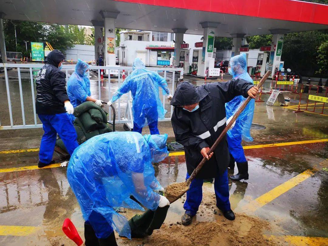 上海石油公司党员来到沪星加油站填装袋沙,放置于加油站出入口的