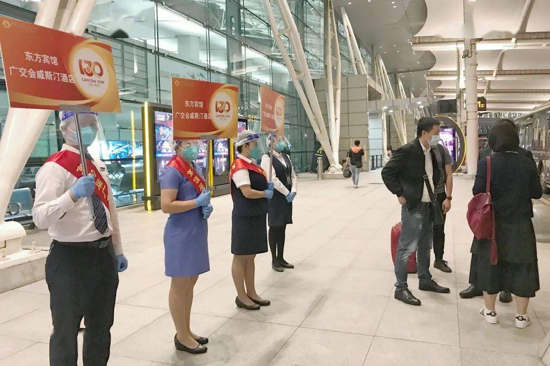 在广交会嘉宾接待处,空港之旅的工作人员们统一佩戴绶带,手举接机牌