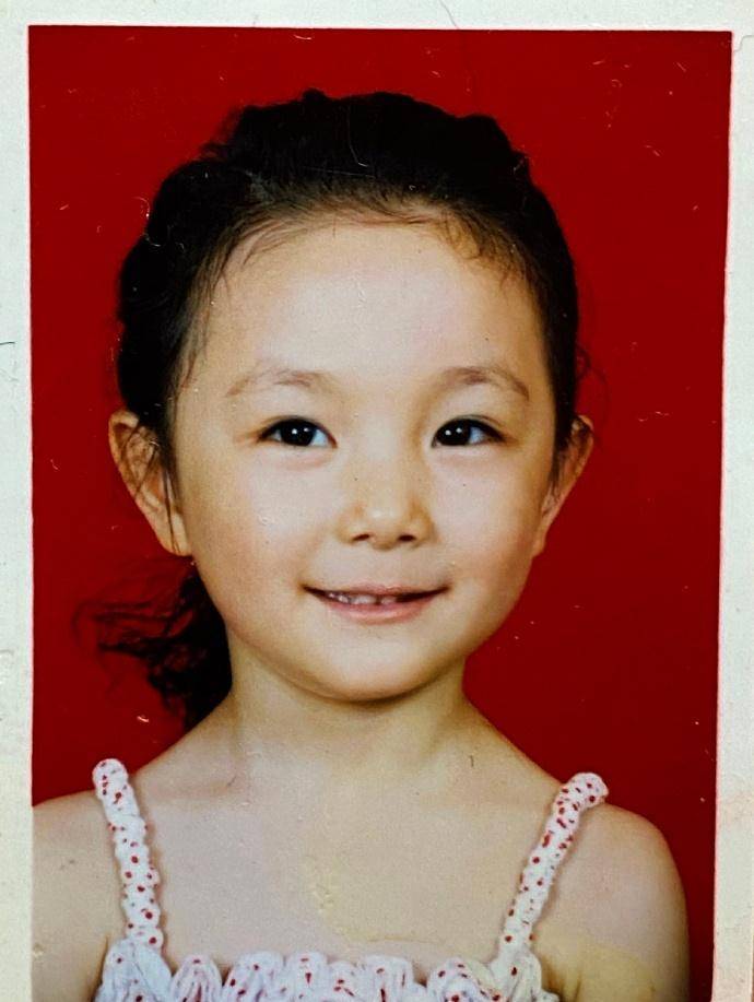 第一张留着长发,戴着白色发箍,小女孩文文静静,眼神清澄如水,跟现在的