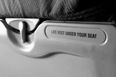 话的意思就是:飞机在地面滑行,起飞和着陆的时候,乘客需要收起小桌板